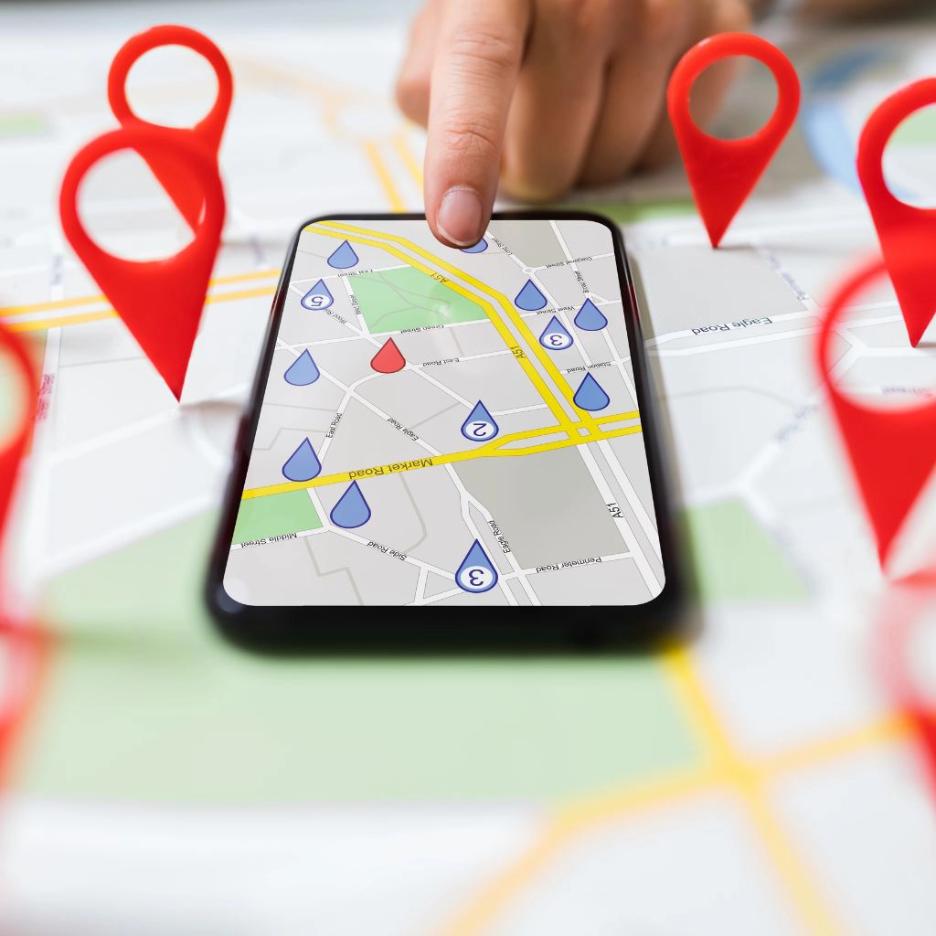 A person touching a mobile phone against map with navigation icons